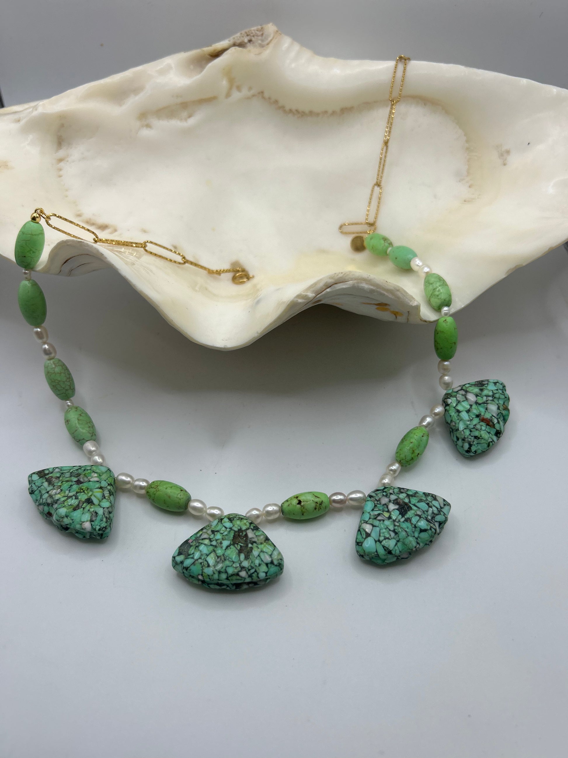 Découvrez ce collier unique en turquoise naturelle forme coquillage et perles de culture. Une création artisanale inspirée de l’océan, alliant élégance, spiritualité et énergie positive.