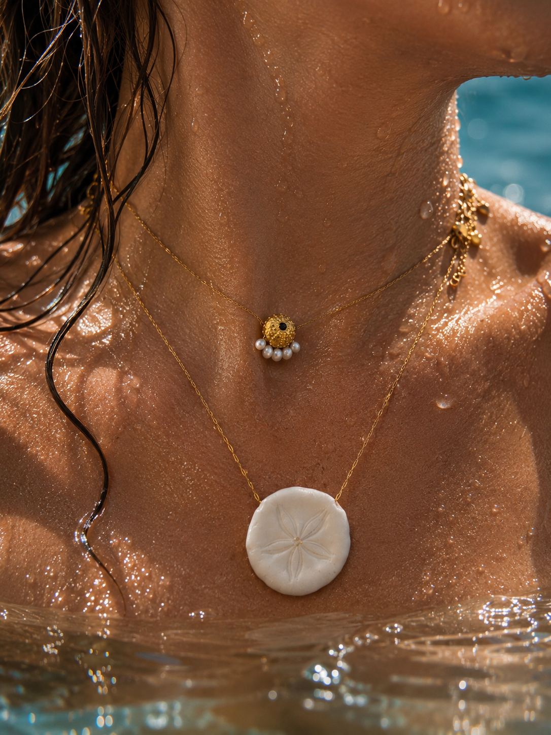 Collier artisanal C’avah de Soie avec véritable dollar des sables naturel, coquillage marin monté sur une chaîne dorée, bijou inspiré de l’océan.